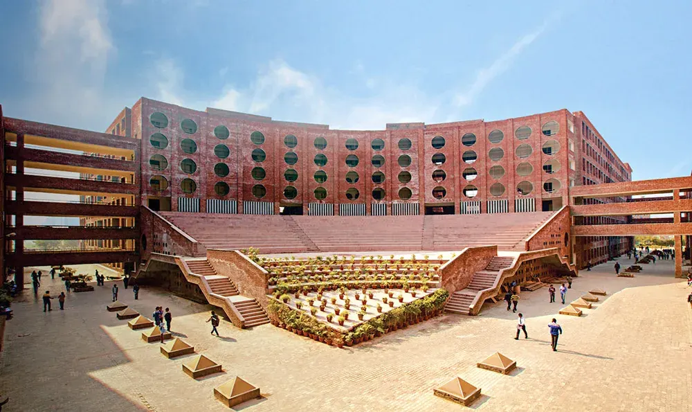 Brick academic building with circular windows and amphitheatre steps at LPU